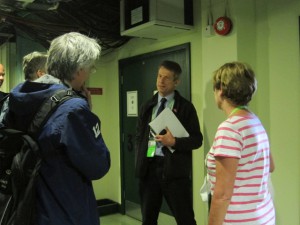 Andy Wright (center) of SIS gave a comprehensive tour of Wimbledon operations to Ravensbourne representatives.