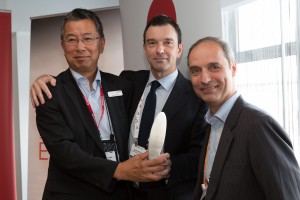 Canon Broadcast’s Ken Koyama (left) presents to Mark Wallace and Sotris Salamouris of the OBS for their work on the Sochi Winter Olympics. [Image: Erik Verheggen]
