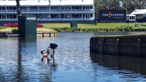 Blake Rowe, from Intel True VR, jumps in to the water at the 17th hole at the Sawgrass Open to check on the Intel True VR camera. (Credit: Intel Corporation)