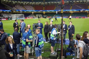 UEFA Broadcast Partner personnel conduct pitch-side stand-ups as the Juventus team warms up on the pitch, Friday June 2